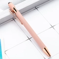 Pink metal stylus ballpoint pen with rose gold accents resting on a modern book - No-line Style (ai-Black Ink) / Mocha Coffee