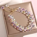 Detail of adjustable gold-tone crystal bead bracelet with iridescent faceted charms - Pink
