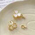 Macro detail of gold-plated clover jewelry clasps with white mother-of-pearl inlay - 18K Gold