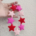 Colorful silicone star keychain with red and pink stars on a matching phone strap - Silicone Star Strawberry Red Series