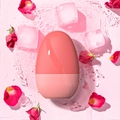 Pink egg-shaped ice face roller floating on water with red rose petals and ice cubes - New Egg Shape - Pink