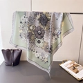 Detailed shot of large square daisy silk scarf with sunflower print and rolled edges - 66-70cm / Green