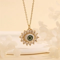 Detail of gold evil eye pendant with green eye center and radiant sunburst cubic zirconia - Green Flower-E4