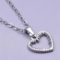 Minimalist silver heart necklace with unique ribbed edges on a lavender background - Pendant with Necklace / Steel