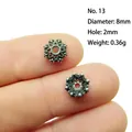 Macro view of an 8mm vintage silver alloy hollow flower spacer bead on a finger - 13#