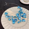 Macro shot of blue multi-layer beaded necklace with irregular resin shells on a plate - Blue Shell Multi-Layer Necklace Z-899