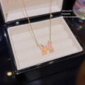 Elegant gold titanium butterfly necklace with iridescent wings in a luxury jewelry box - X674 Phantom Pink Butterfly