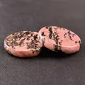Polished round natural rhodonite crystal stones with pink and black vein patterns - Rhodonite