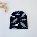 Detail showing knit beanie texture with gray and white dinosaur silhouette patterns - Black with Blue Dinosaur (5061509487930)