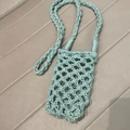 Close-up of mint green hand-woven cotton phone bag with thick braided strap detail - Lake Green