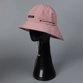 Detailed close-up of pink nylon sun hat featuring adjustable wind cord and brand label - M (56-58cm) / Pink