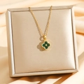 Elegant gold four-leaf clover pendant necklace with green stones and sparkling zircon crystals - Gold/Green Zirconia
