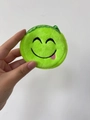 Mini green plush coin purse with embroidered winking face and soft texture - Green