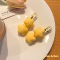 Set of two vibrant yellow star-shaped hair clips in Y2K style, length approx 6.5cm - Chubby Cream Yellow Stars (Set of 2)