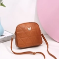 Brown quilted shell crossbody bag with a white butterfly metal clasp and adjustable strap - Brown