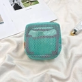 Detail of mint green mesh mini makeup bag showing its square grid texture and leather tag - Green/Rose Red