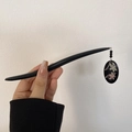 Elegant black wooden hair pin with oval floral pendant and decorative black beads - Oval Flower Hair Stick (FS0101)