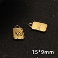 Macro detail of golden butterfly charm with Beauty engraving and 15x9mm dimensions - Butterfly Engraved Pendant / Gold