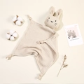 Detail of beige cotton muslin bunny security blanket with cute embroidered face and knotted corners - Light Khaki
