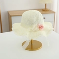 Close-up of straw sun hat featuring fabric roses, a pearl, and lace brim detail - Hat / Cream