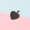 Detail of 25mm black heart-shaped pendant with metal ring on two-tone background - Black