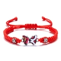 Detail of red braided cord bracelet featuring enamel butterfly charm and rhinestone beads - Red