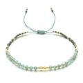 Detail of bohemian handmade beaded bracelet with blue crystals and green adjustable cord - Lake Blue