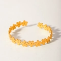 Detailed view of the gold-plated metal flower design on an open-end textured bangle - Gold Daisy Style (2-DQ-001) / 18K Gold / Gold