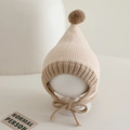 Detailed knit texture and soft pompom on a two-tone baby winter bonnet with earflaps - 6-24 Months / Beige