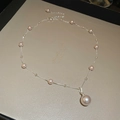 Primer plano del collar con colgante de perla irregular y pequeñas perlas en cadena de plata - Plateado