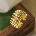 Macro shot of 18K gold plated multi-layer ribbed ring with four sparkling zircon stones - Multi-layer Wave Four Zircon / Gold