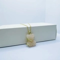 Pink crystal bear necklace with gold star detail on a minimalist display stand - Necklace / Light Pink