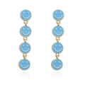 Detail view of long golden earrings featuring four linked blue enamel smiley face pendants - Blue