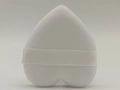 Detailed close-up of a white heart-shaped plush powder puff with a satin ribbon strap - White