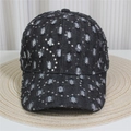 Close-up of black denim baseball cap with silver sequins and distressed torn details - No.27/Black Denim/Sequin Worn