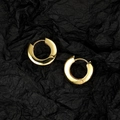 Polished chunky gold hoop earrings set on elegant black textured background - Gold