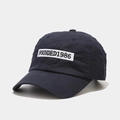 Detail of navy blue cotton baseball cap featuring high-quality 1986 embroidery text - Adjustable / Navy Blue