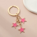 Pink pentagram star keychain pendant with gold alloy frame on aesthetic background - Light Pink