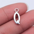Close-up of a silver-colored alphabet Q alloy pendant charm on a fingertip - Letter Q (B15670) / Antique Silver