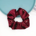 Detailed close-up of a burgundy velvet scrunchie featuring gold foil star patterns - Burgundy