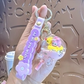 Llavero de arena movediza púrpura con muñeca rosa y colgante de patito amarillo - Paleta