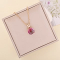Detailed top view of a faceted pink and green gradient glass pendant on a gold twisted chain - Rose Red