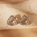 Detail of silver hollow triangle earring with hammered texture on beige stone and silk - Irregular Hollow Triangle Style