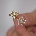 Elegant gold snowflake stud earrings featuring sparkling clear cubic zirconia stones - Stud Earrings / Gold