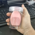 Pink multi-angle cut makeup sponge stored in a clear cylindrical plastic jar with white lid - Cylindrical Box / Honey Pink