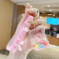 Pink ice cream keychain with liquid sand, pastel shell charms and silicone wrist strap - Quicksand Shell - Camera