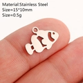 Polished stainless steel clownfish charm shown on fingertip for size reference - Clownfish / Silver