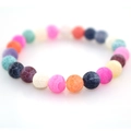 Close-up of colorful natural weathered dragon vein agate stone beads on elastic bracelet - Colorful
