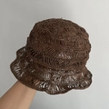 Detail of hand-woven hollow crochet straw bucket hat with breathable wave-edge design - M / Coffee