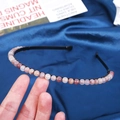 Handmade 6mm pink crystal stone headband on a black wire base held by a hand - 6mm Violet